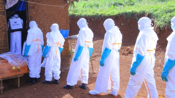 Health workers wearing protective equipment carry out disinfection procedures before transporting the body of a person who died with suspected Ebola infection in Mongbwalu village of Ituri province in eastern Democratic Republic of the Congo, on May 25, 2026. 