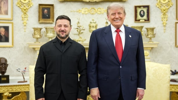 A smiling Volodymyr Zelenskyy and Donald Trump smiling inside the White House