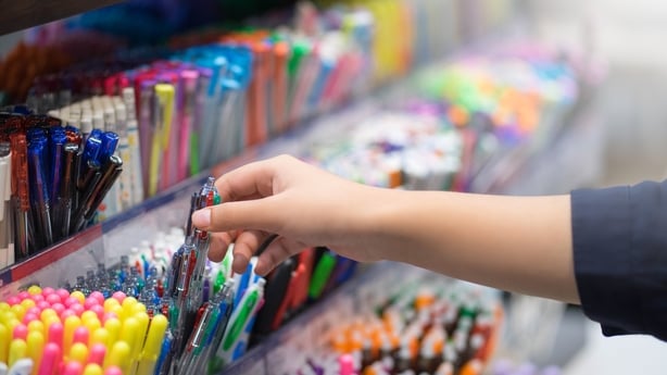 Close up hands choosing school stationery in the supermarket.