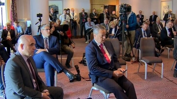 Vincent Kearney listening to a press conference