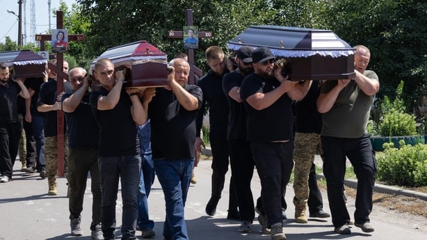 Pallbearers carry the coffins of family members who were killed on July 30, 2026, during a funeral ceremony in Kryvyi Rig on August 3, 2026, amid the Russian invasion of Ukraine. A Ukrainian emergency services official had previously told AFP that the deaths of six people had been confirmed, while f