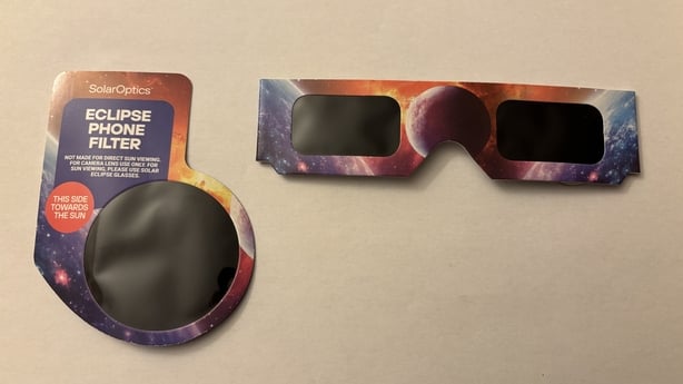 Typical eclipse glasses and a hand-held phone filter to take photos of the eclipse, multiples of each typically provided in one cost-effective pack. Image: Kevin Nolan / TU Dublin