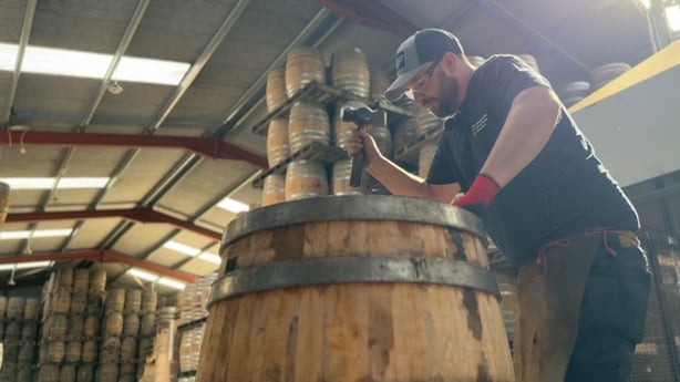 Cooper Ian Leonard uses a hammer on a rare Irish oak whiskey barrel