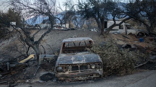 a burnt car after a wildfire in Porto Germeno, Greece