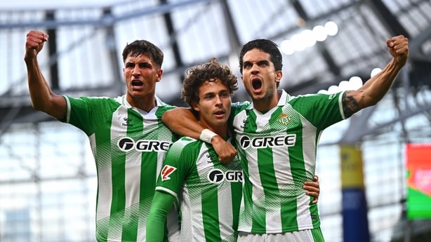 5 August 2026; Rodrigo Riquelme of Real Betis, centre, celebrates with teammates Facundo Bernal, left, and Marc Bartra after scoring his side's first goal during the pre-season friendly match between Arsenal and Real Betis at the Aviva Stadium in Dublin. Photo by Tyler Miller/Sportsfile