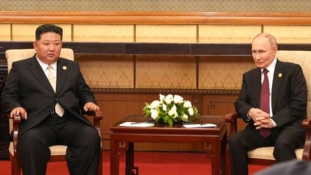 North Korea's leader Kim Jong Un sits alongside Russia's President Vladimir Putin during a meeting in Beijing