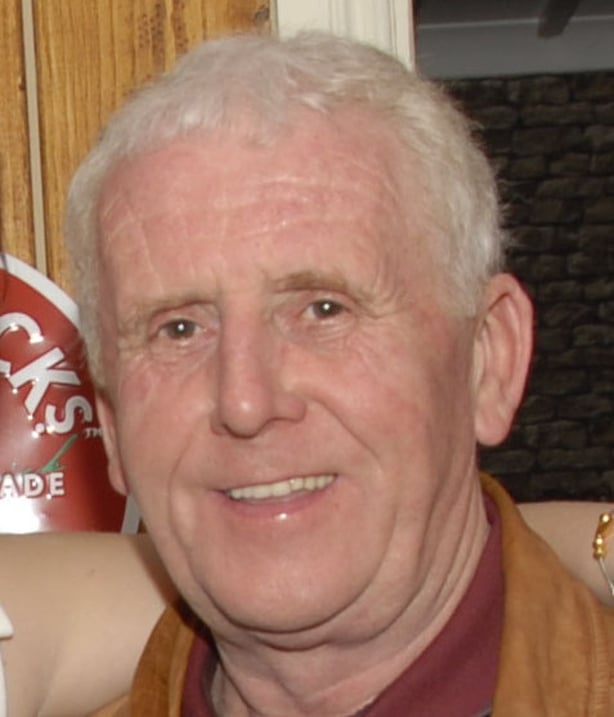 An Elderly man posing for a picture