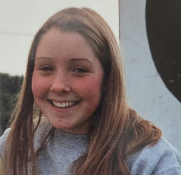 A girl smiling while posing for a picture