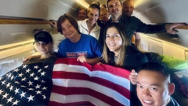 Robert Gilman on a plane surrounded by people