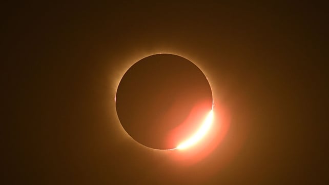The Sun's corona glows as the Moon completely blocks the Sun during the totality phase of the total solar eclipse