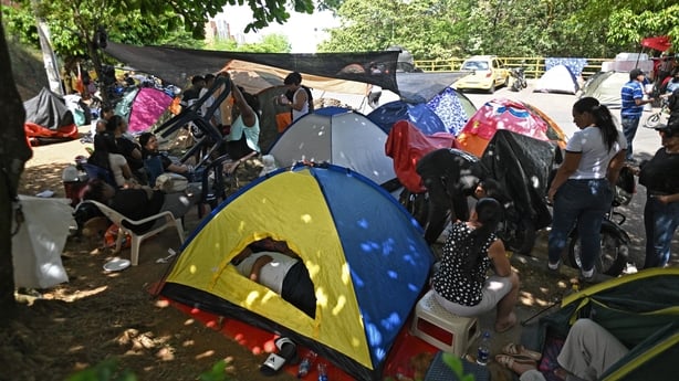 People camp in front of their damaged homes at the Altos de Santa Elena neighborhood in Cali,