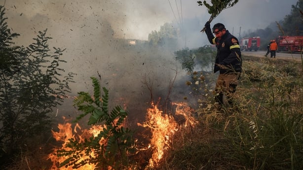 Firemen work to extinguish a wildfire near the village of Siviri, in northern Greece