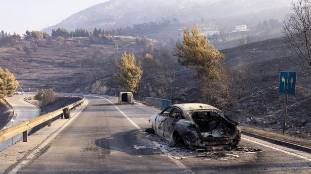 This photograph shows burnt cars on a road after a wildfire near the town Omis, some 30 kilometres south of Split, on August 14, 2026