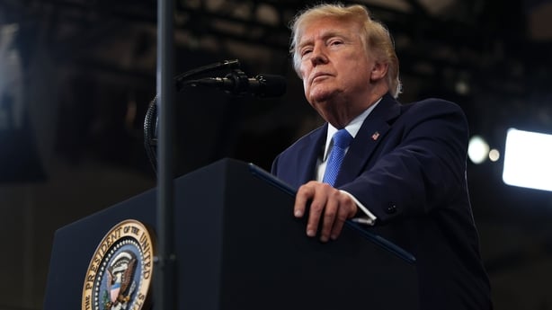 US President Donald Trump pauses while delivering remarks at the David S. Mack Center for Training and Intelligence