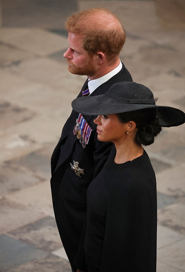 Britain's Prince Harry, Duke of Sussex (L) and Meghan, Duchess of Sussex (R) attend the State Funeral Service for Britain's Queen Elizabeth II at Westminster Abbey in London on September 19, 2022. (Photo by PHIL NOBLE / POOL / AFP)
