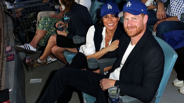Prince Harry and Meghan pose for a photo during Game Four of the 2025 World Series