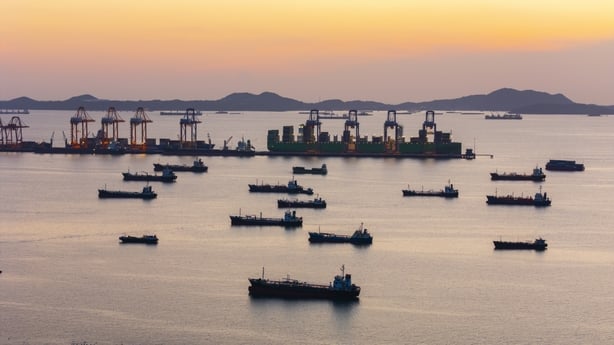 Aerial view oil ship tanker waiting on the sea for load or unload oil from refinery at dusk. Business logistics import export shipping or freight transportation.