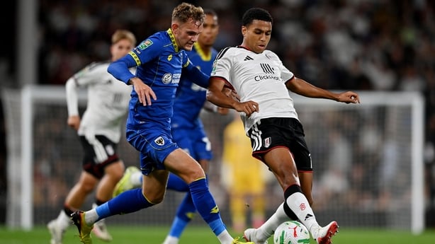 LONDON, ENGLAND - AUGUST 27: Shea Charles of Fulham is challenged by Callum Maycock of AFC Wimbledon during the Carabao Cup Second Round match between Fulham and AFC Wimbledon at Craven Cottage on August 27, 2026 in London, England. (Photo by Patrick Khachfe/Getty Images)