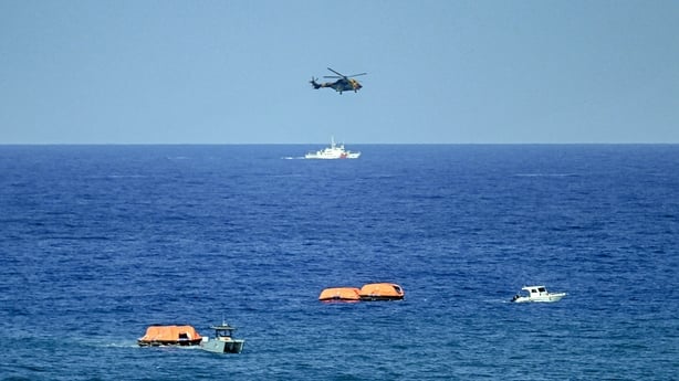 Turkish vessels, aircraft, and rescue rafts are pictured off the port of Kyrenia
