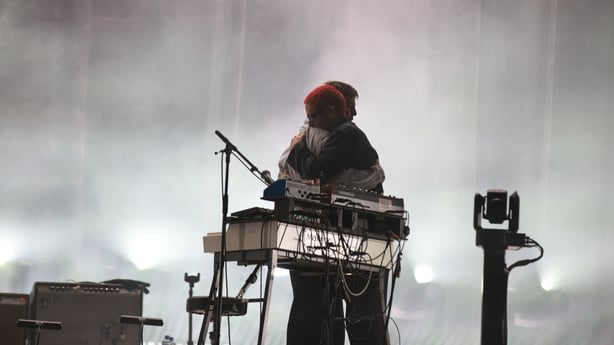 Grian Chatten (L) and Conor Curley (R) of Fontaines D.C. embrace in a hug after their headlining show during Electric Picnic 2026 at Stradbally Hal