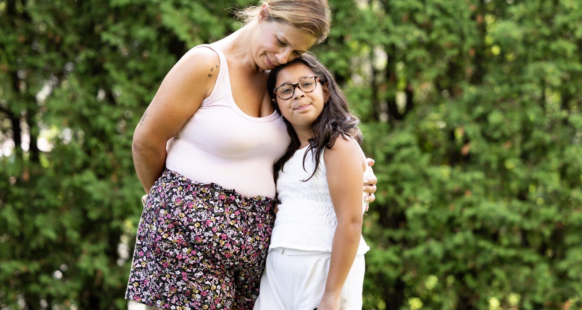A woman and a young girl outside.