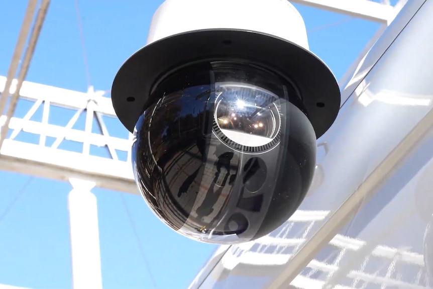 A black ball looking camera attached to a van roof.