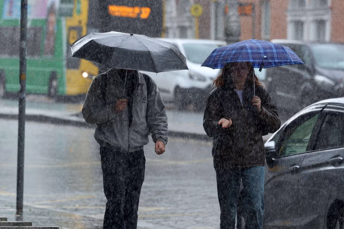 Commuters out in heavy rain on Baggot Street, Dublin