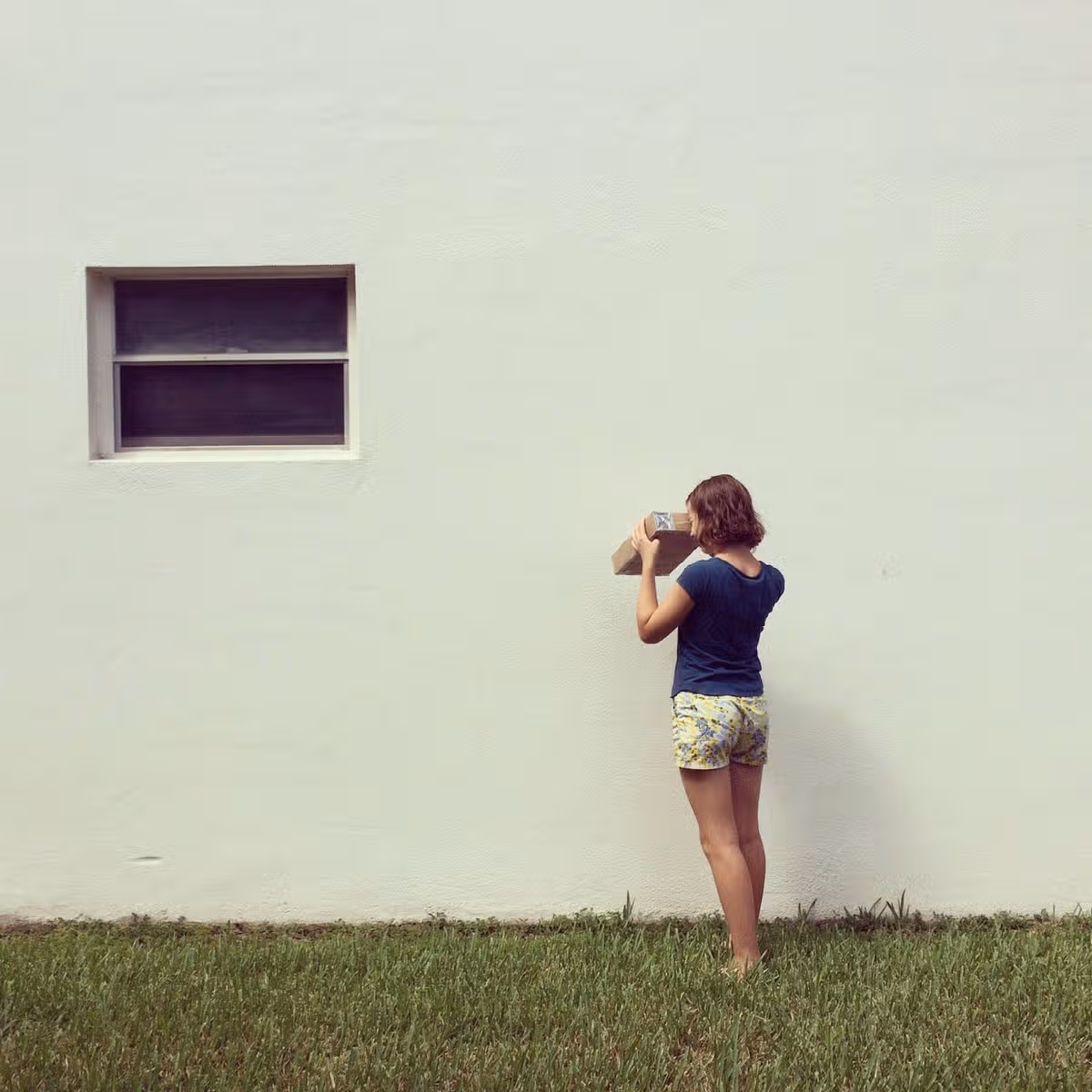 Girl Looking Through Pinhole Projector to Watch Eclipse