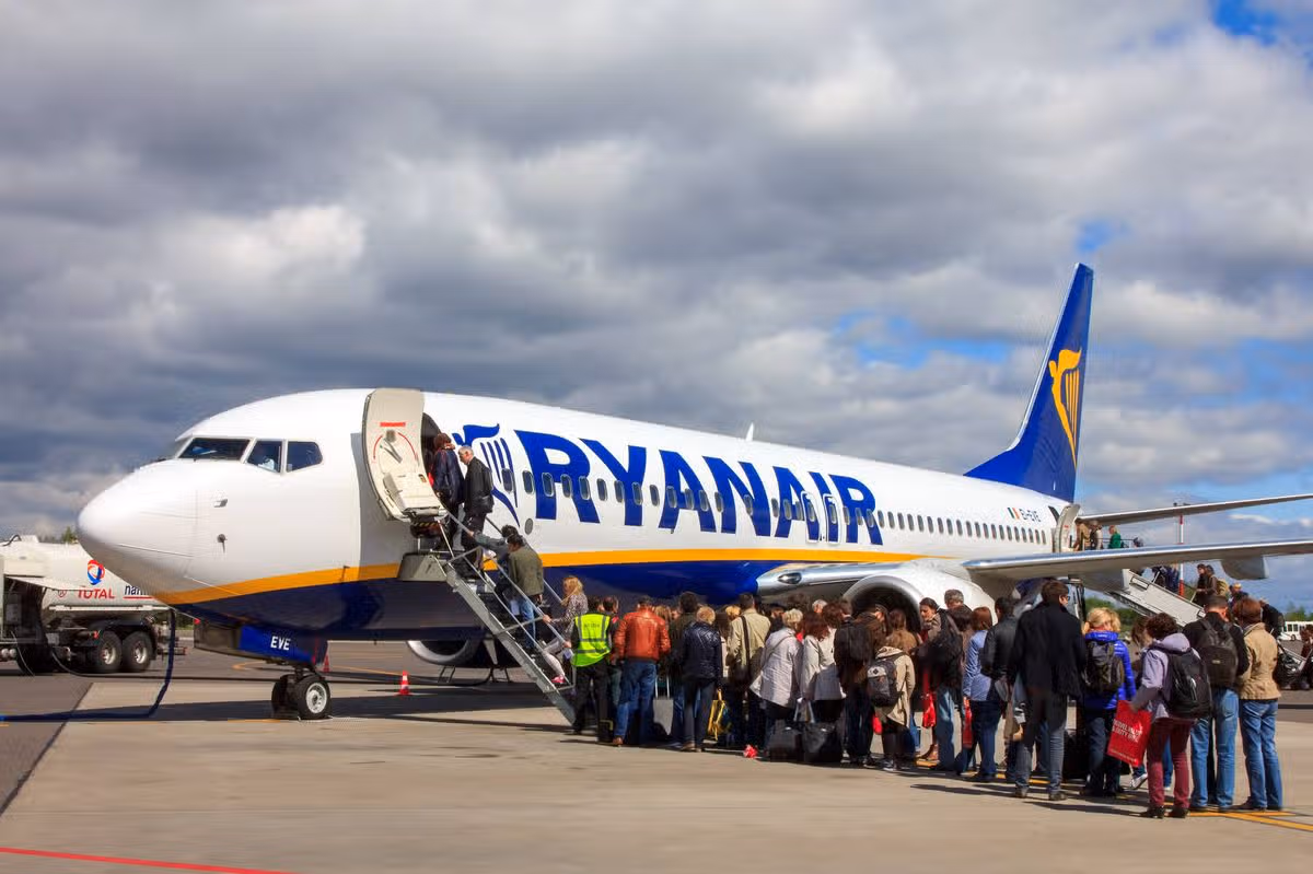 Vilnus, Lithuania - May 2, 2014: People boarding a Ryanair on the route Vilnius - Paris (Beauvais). Ryanair is one of the largest low-cost European airline by scheduled passengers carried.