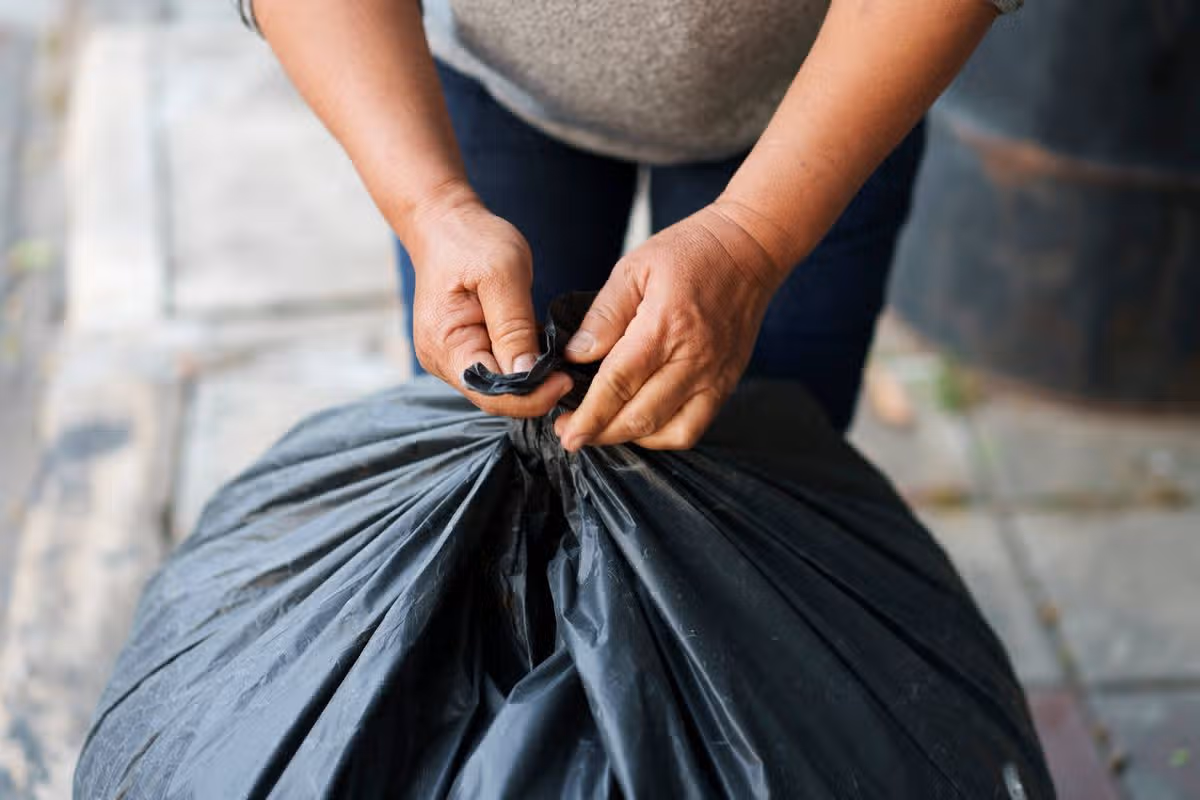 selective focus hands try to tie a trash bag for recycle