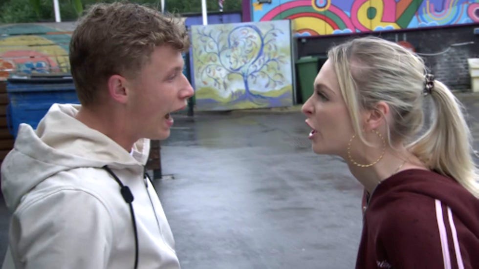 coronation street dylan wilson lauren bolton two people arguing outside near a colorful mural.