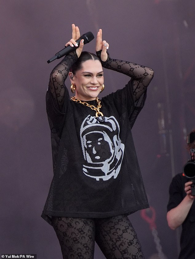 Over the lace bodysuit she wore a sheer black and white T-shirt and accessorised with plenty of chunky gold jewellery