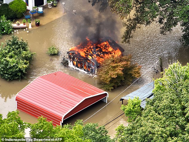 A building catches on fire due to damaged caused by floods in this Indiana town