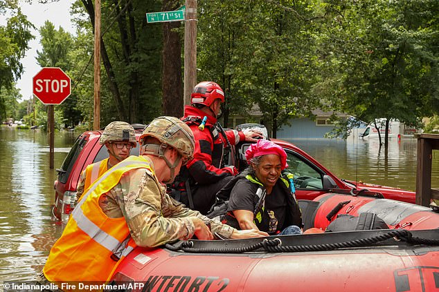 Rescuers also used boats to save people stranded in inundated along the White River as floodwaters rose high and higher on Saturday