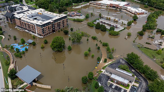 Five people have been found dead with more missing as unceasing rain causes devastating floods across Indiana. Pictured is submerged Noblesville
