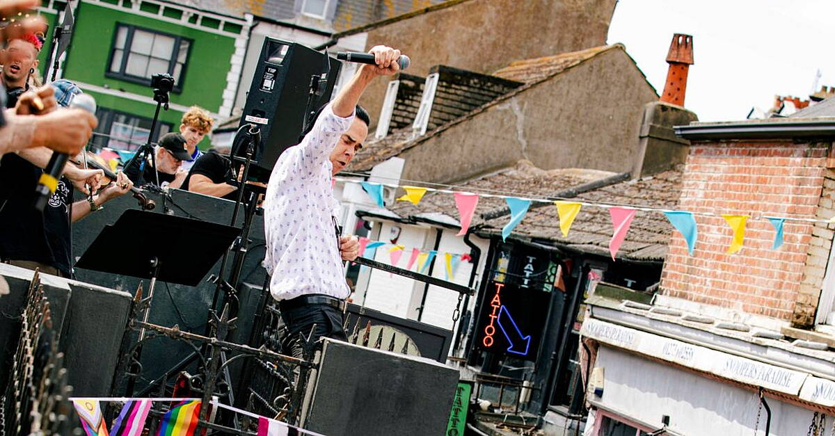 Nick Cave And The Bad Seeds perform surprise gig on roof of Brighton record shop