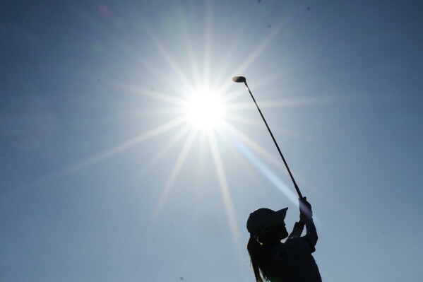 Shiho Kuwaki, of Japan, drives off the 16th tee during the third round of the Women's British Open golf championship in Lytham St Annes, England, Saturday, Aug. 1, 2026. (AP Photo/Jon Super)