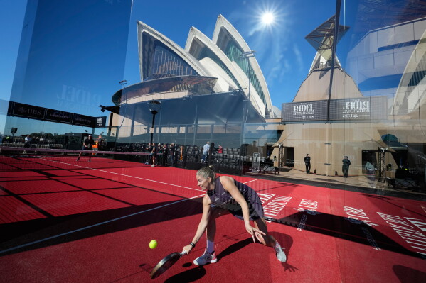 Spanish player Alejandra Salazar hits the ball on a padel court installed at the Sydney Opera House for an invitational tournament in Sydney, Friday, Aug. 14, 2026. (AP Photo/Rick Rycroft)