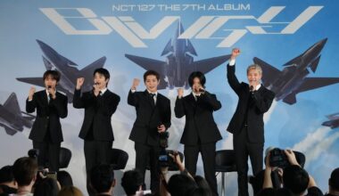 Members of K-pop group NCT 127 pose during a press conference to introduce their new album