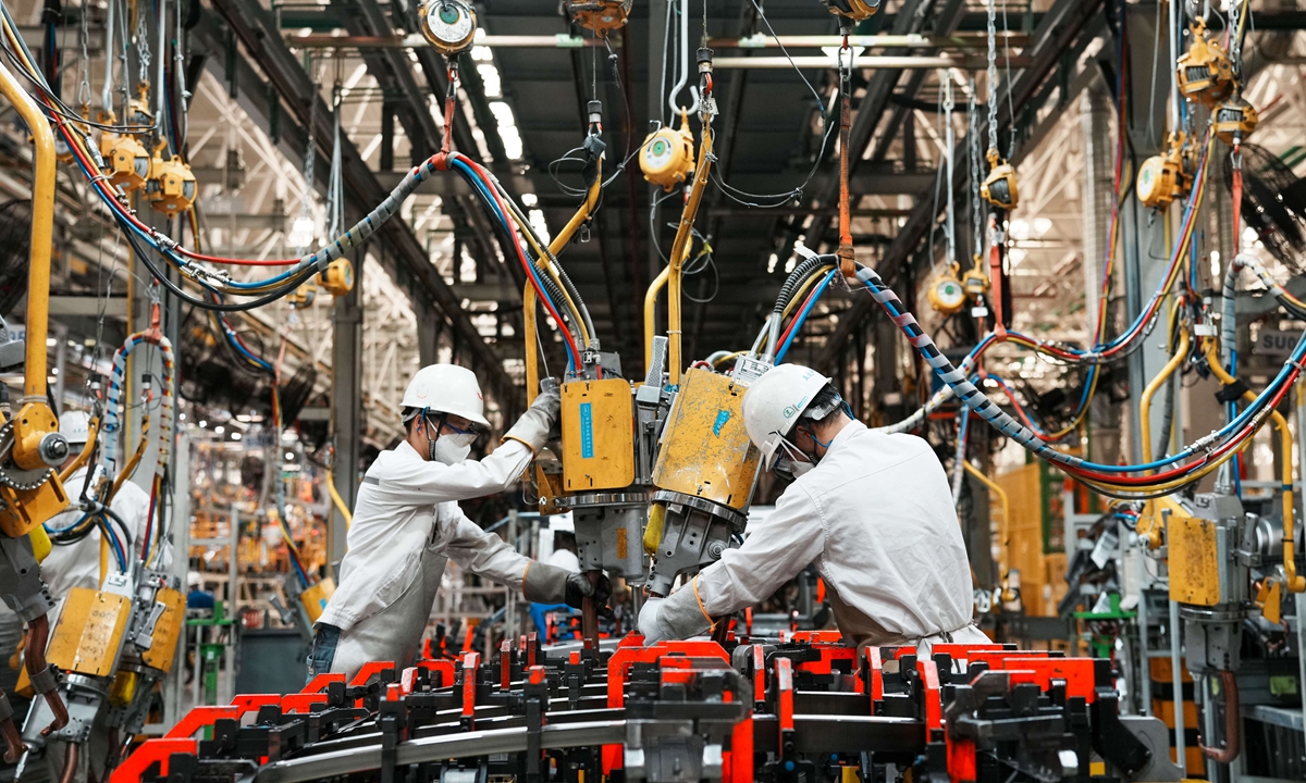 Workers assemble NEVs in Liuzhou, South China