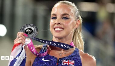 Keely Hodgkinson in a crown with her coaches in the background