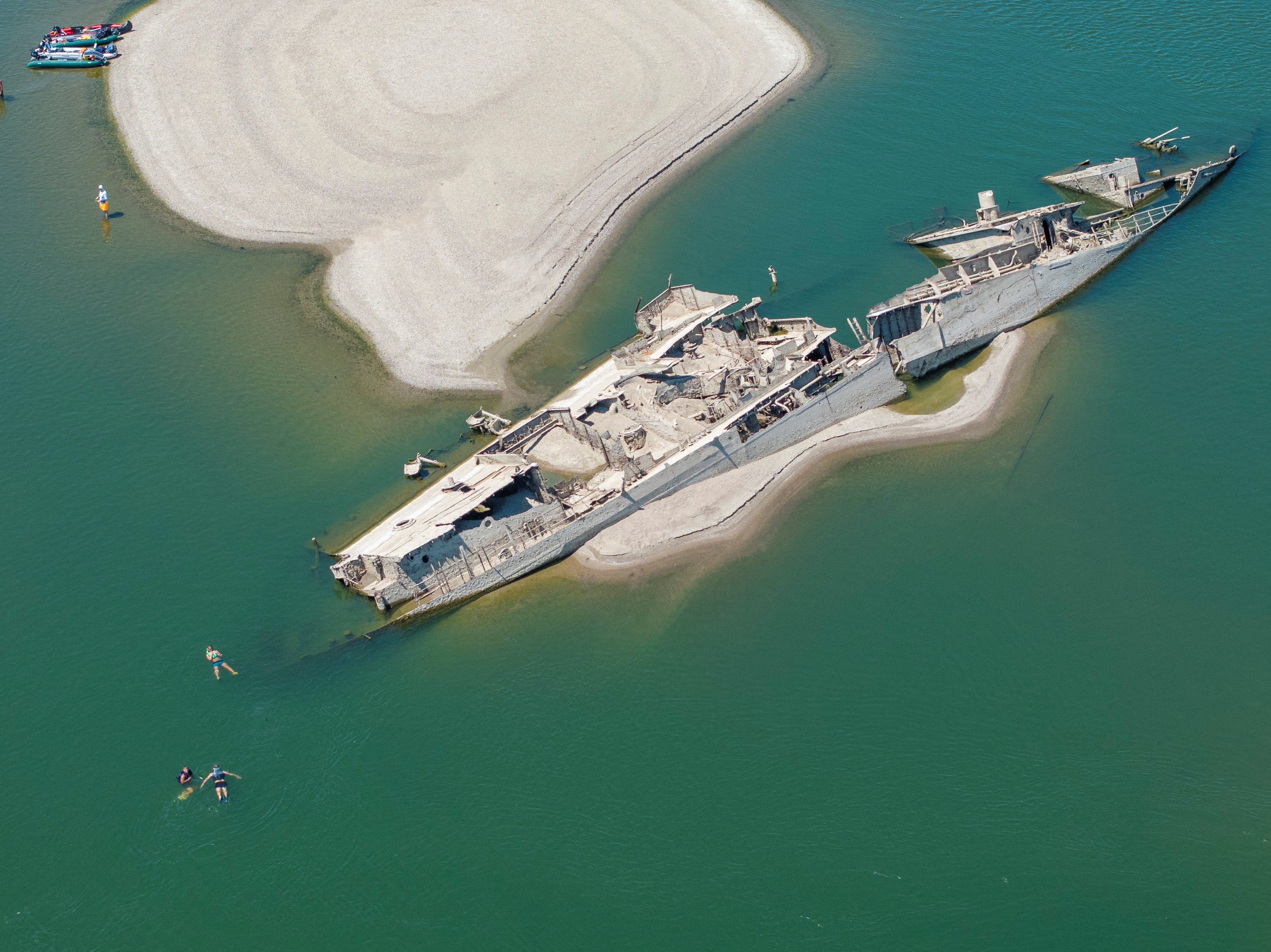 A sunken Nazi warship from World War II was exposed due to low Danube River levels caused by drought and extreme heat in Prahovo, Serbia, last week