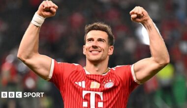 Leon Goretzka celebrates Bayern Munich's win the DFB Pokal final by raising both arms above his head