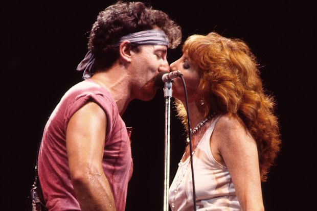 American Rock musicians Bruce Springsteen, on guitar, and backing vocalist Patti Scialfa of the E Street Band, perform onstage during the 'Born in the USA' tour, at Giants Stadium, East Rutherford, New Jersey, August 22, 1985. (Photo by Gary Gershoff/Getty Images)