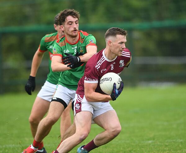 Creggs midfielder Shane Dowd turns away from his St. Michael's counterpart, Niall Sheerin, during Sunday's intermediate football championship match at Enfield. Picture: Gerard O'Loughlin
