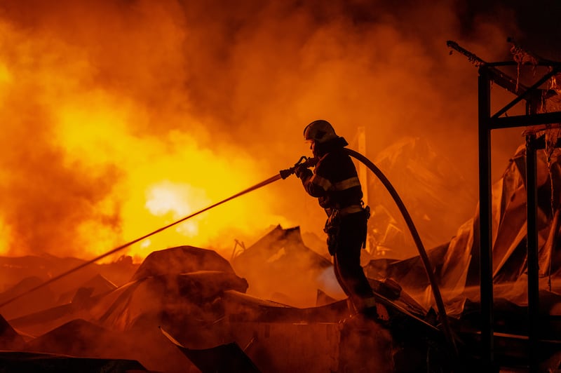 Firefighters tackle a blaze after Russian missiles hit a warehouse in Kyiv, Ukraine. Photograph: Dan Bashakov/AP