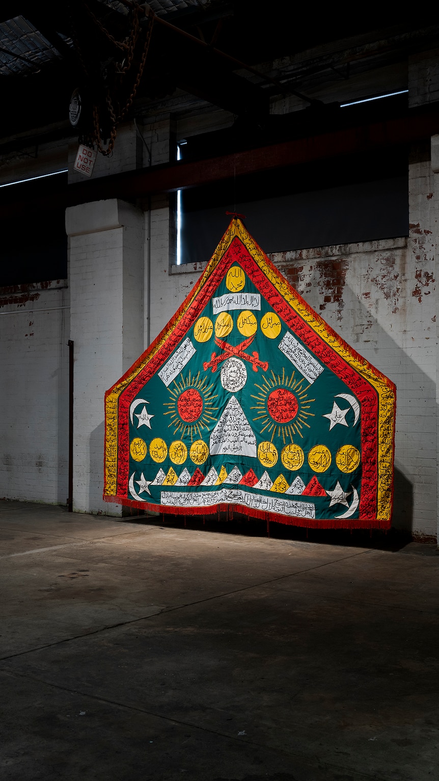 A bright colourful house shaped tapestry