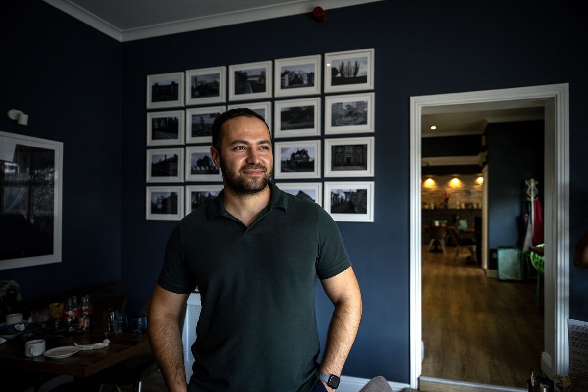 Ali Fincan is pictured beside a wall of historic photographs celebrating Midleton’s past inside Lumi Café in Townspark, Midleton. Picture: Chani Anderson