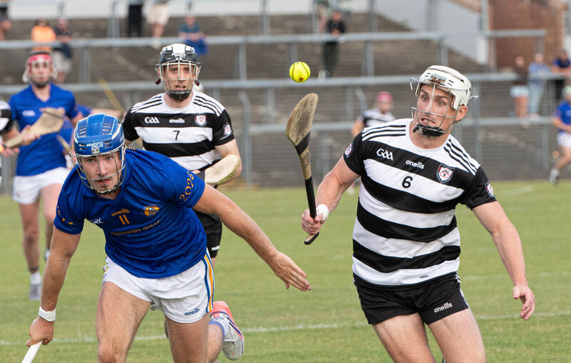 Midleton's Tommy O'Connell tries to control the ball, under pressure from St Finbarr's Conor McCarthy. Picture: Howard Crowdy