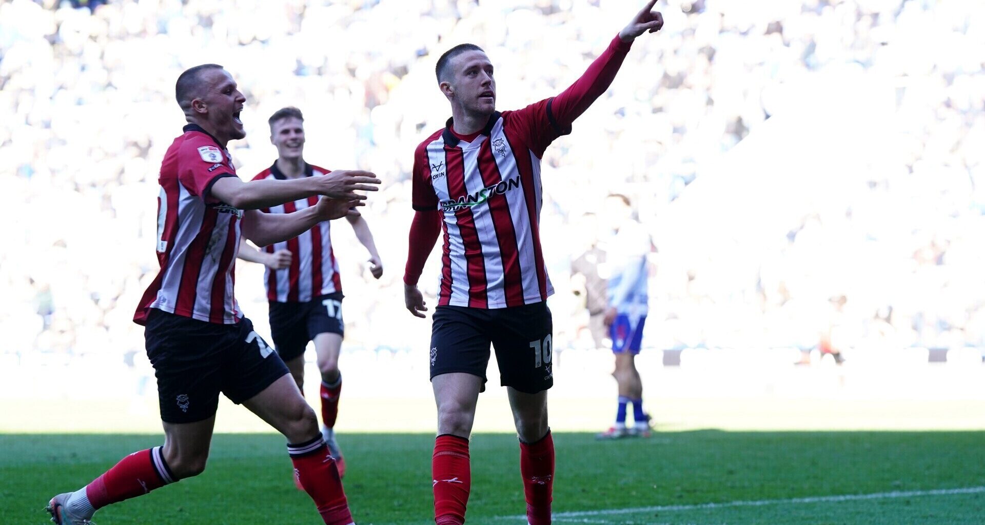 Lincoln City's Jack Moylan (right) celebrates. Pic: Jacob King/PA Wire.